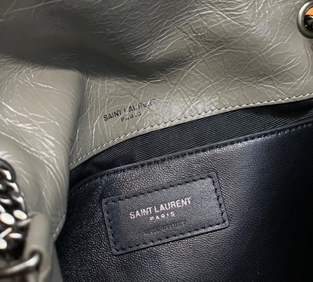 Saint Laurent Paris label inside pocket on metallic gray and black shoulder bag