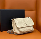Cream quilted shoulder bag with top flap, YSL-style monogram, and chain strap.