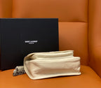 Cream leather shoulder bag, flap turned back to show interior, with chain strap.