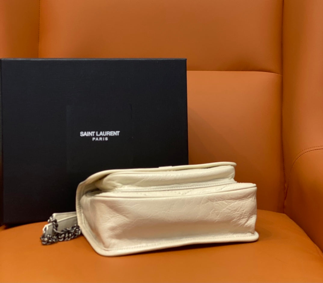 Cream leather shoulder bag, flap turned back to show interior, with chain strap.