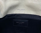 Cream leather lining with Saint Laurent Paris stamp on inner panel and strap.