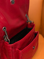 Red leather shoulder bag with black interior pocket and chain strap