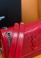 Red quilted shoulder bag with chain strap and YSL emblem