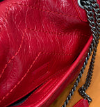 Red quilted leather flap detail with chain strap