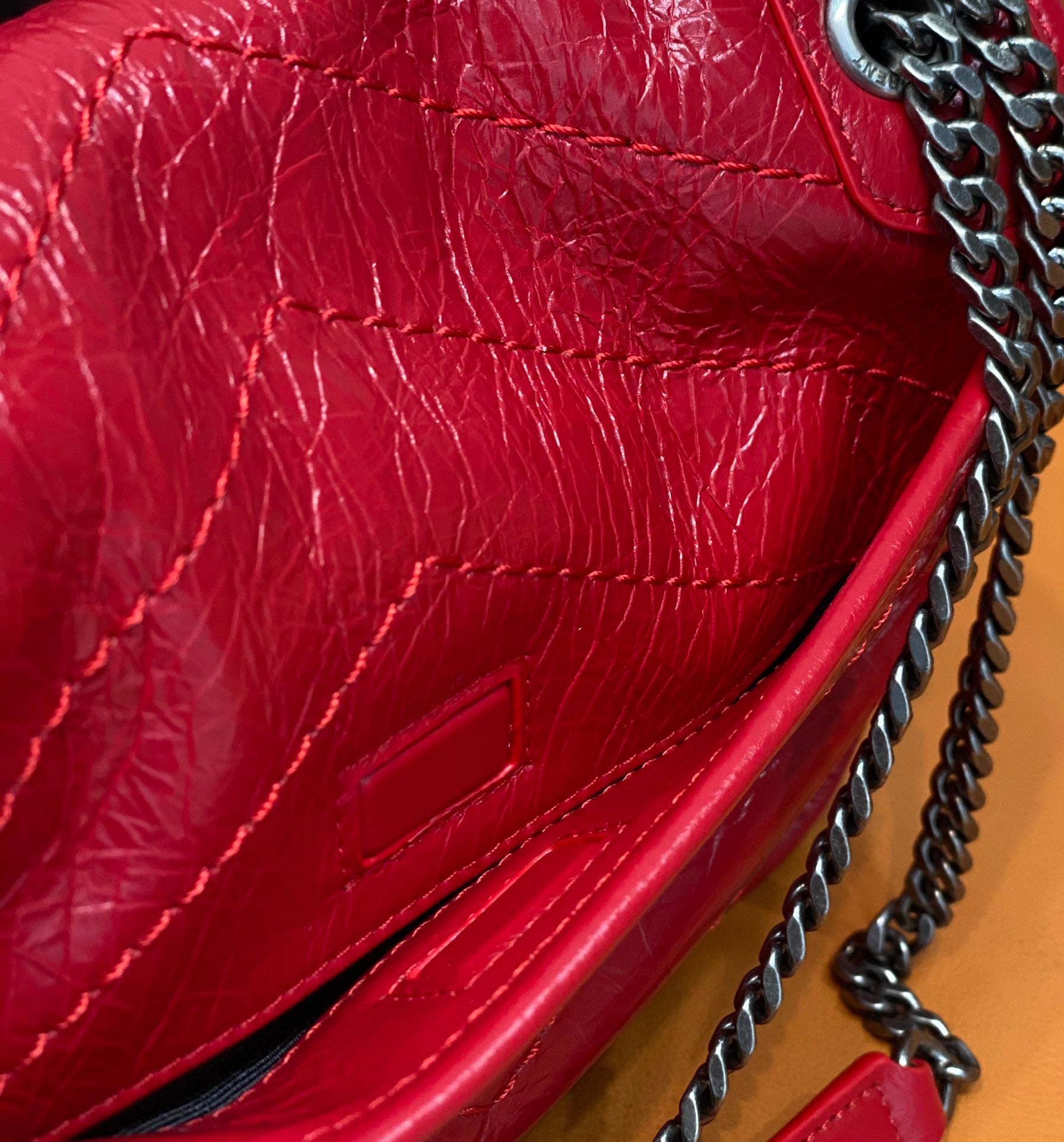 Red quilted leather flap detail with chain strap