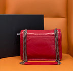 Red quilted shoulder bag with chain strap and layered flap