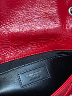 Black leather patch with Saint Laurent Paris text on red bag