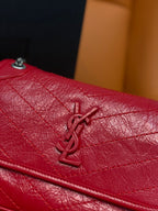 Red leather flap with YSL logo and stitched detailing