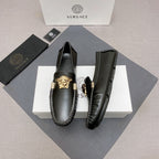 Versace black leather loafer shoes with gold medallion detail and contrast stitched edges