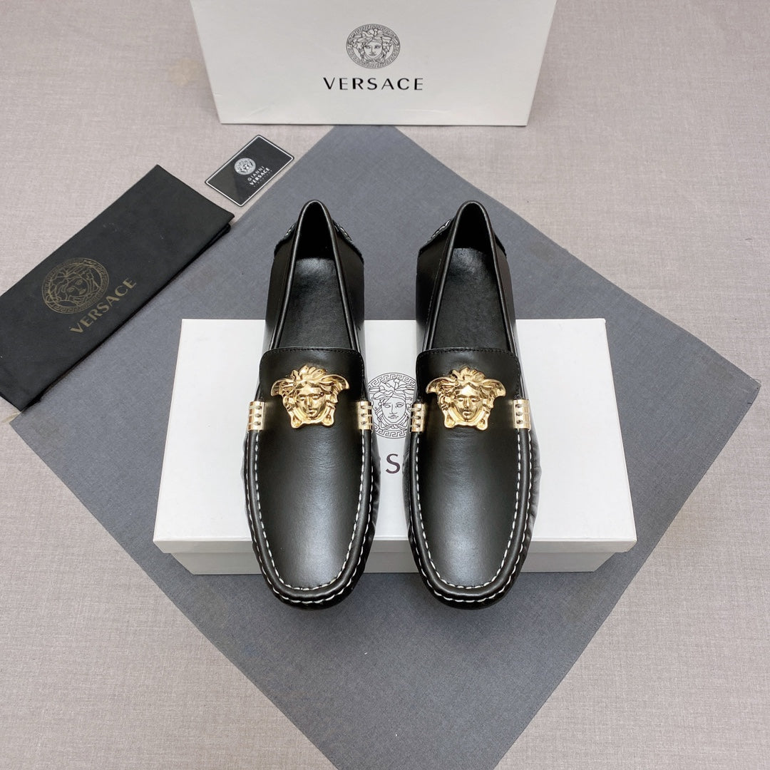 Versace black leather loafer shoes with gold medallion on the vamp and white contrast stitching