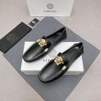 Versace black leather loafers with gold lion medallion on top and contrast white stitching