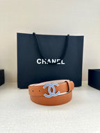 Tan leather belt with prominent blue-and-silver logo buckle centered on strap