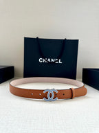 Light tan leather belt with blue and silver logo buckle and round hole markings
