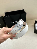 Chanel belt end view: white leather strap with blue crystal CC buckle in hand