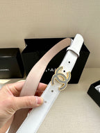 Chanel belt with white strap, pink lining, and blue crystal CC-style buckle detail