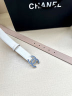 Chanel belt pair laid flat: white and pale pink straps with blue crystal CC buckle