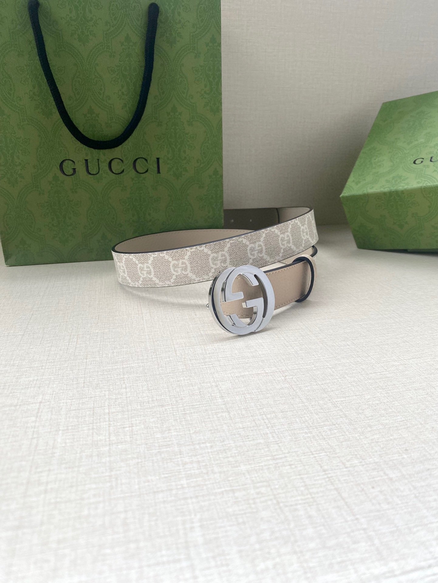 Gucci belt with white monogram fabric strap and silver GG buckle