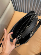 Black leather handbag interior with zip compartments and silver hardware
