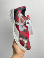 Basketball sneaker heel and side view with red camo upper, dark collar, white sole.