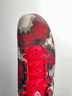 Basketball sneaker front view with red laces, red camo toe, dark eyestay and lining.