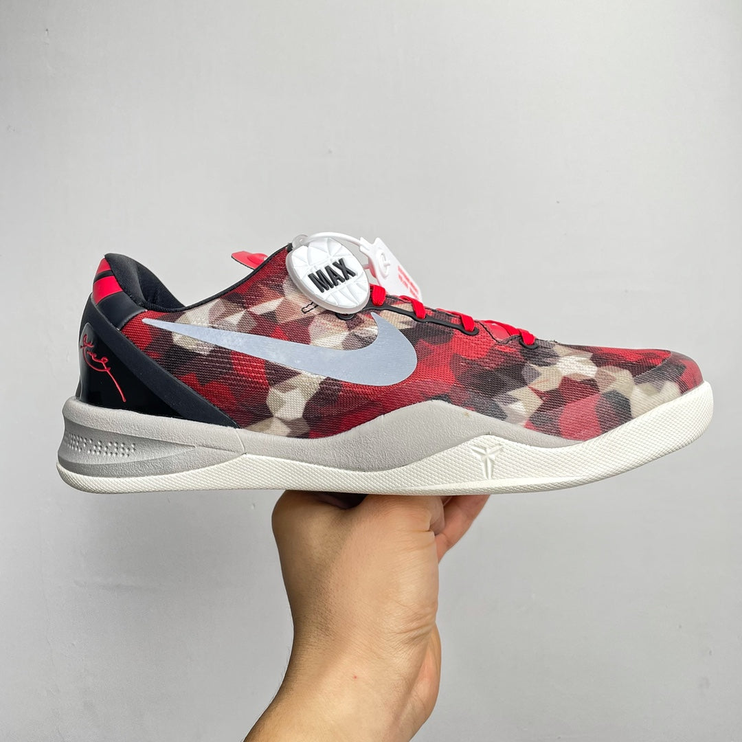Basketball sneaker with red camo upper, black collar, white swoosh and midsole.