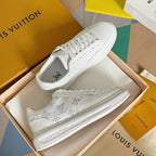 White lace-up low-top sneakers with monogram pattern on the upper, pair view
