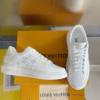 White lace-up low-top sneakers with monogram pattern and textured leather upper