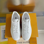 White lace-up low-top sneakers with monogram logo at the heel, front-facing pair