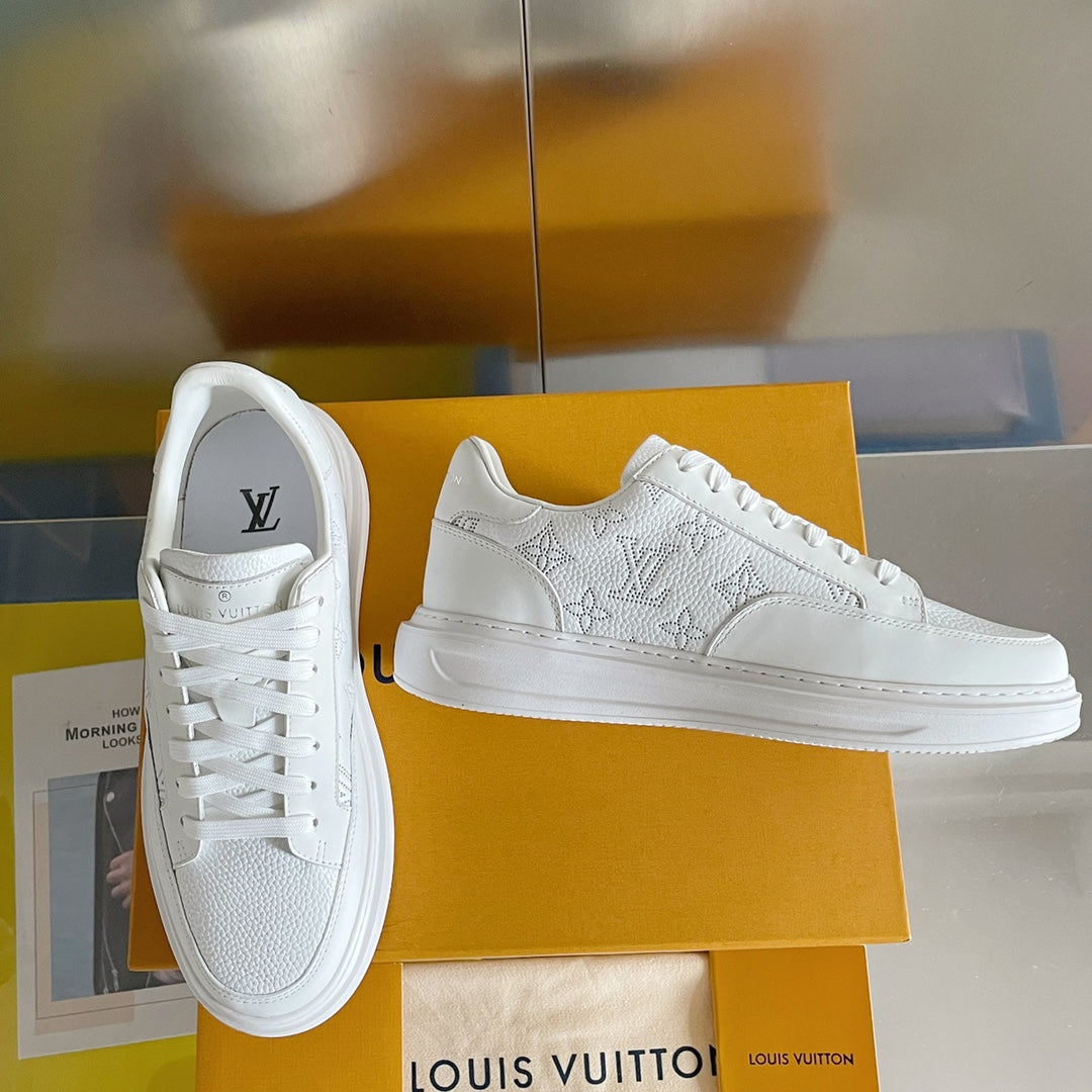White lace-up low-top sneaker with monogram pattern detail on the side