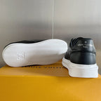 Back view of black lace-up sneaker with white sole and treaded outsole