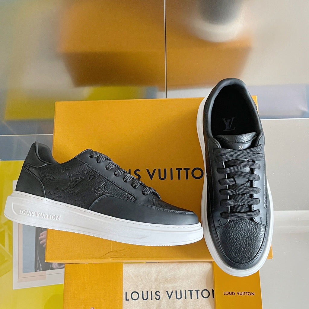 Black lace-up sneaker with white sole and embossed logo at tongue