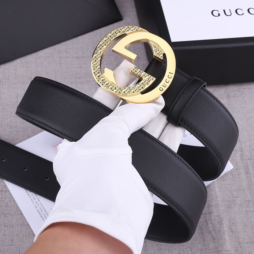 Black leather Gucci belt with gold-toned GG buckle and wide strap detail