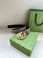 Two-tone leather belt with interlocking GG buckle; taupe strap and dark backing