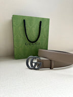 Leather belt with interlocking GG buckle; taupe strap with smooth finish and dark edge