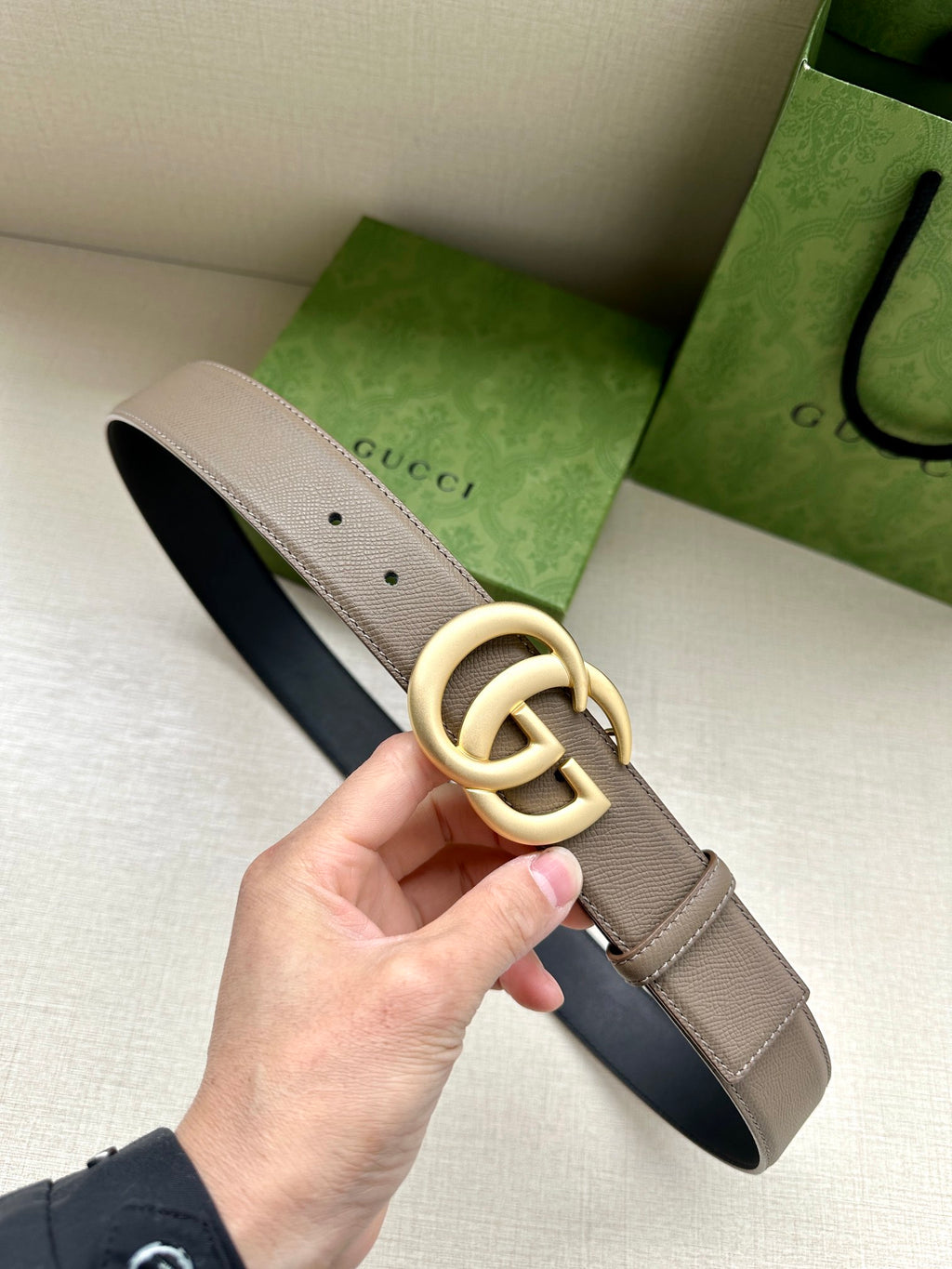 Two-tone leather belt with interlocking GG buckle; beige strap and dark navy backing