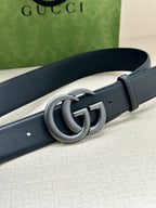 Dark blue leather belt with silver GG interlocking buckle detail.