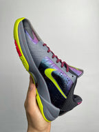 Basketball shoe side view with neon yellow sole, light gray upper, purple highlights, red laces