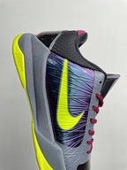 Basketball shoe heel and side view with neon yellow sole, purple graphic, red laces