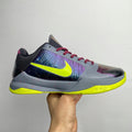 Basketball shoe in light gray with neon yellow sole, purple/blue panels, red laces