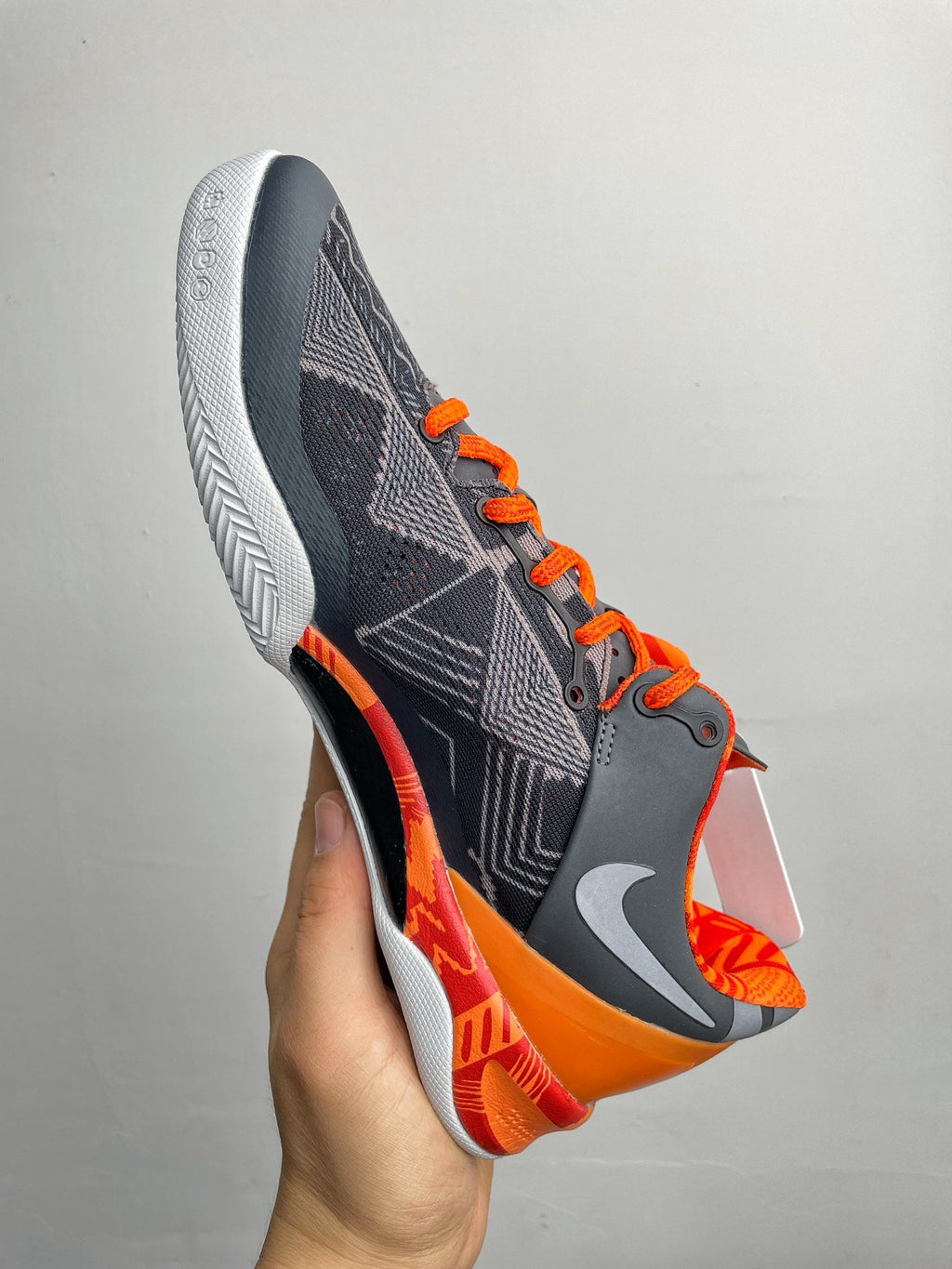 Basketball shoes, dark navy upper with orange accents and white textured sole