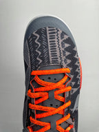 Basketball shoes, dark navy toe with orange laces and white interior lining