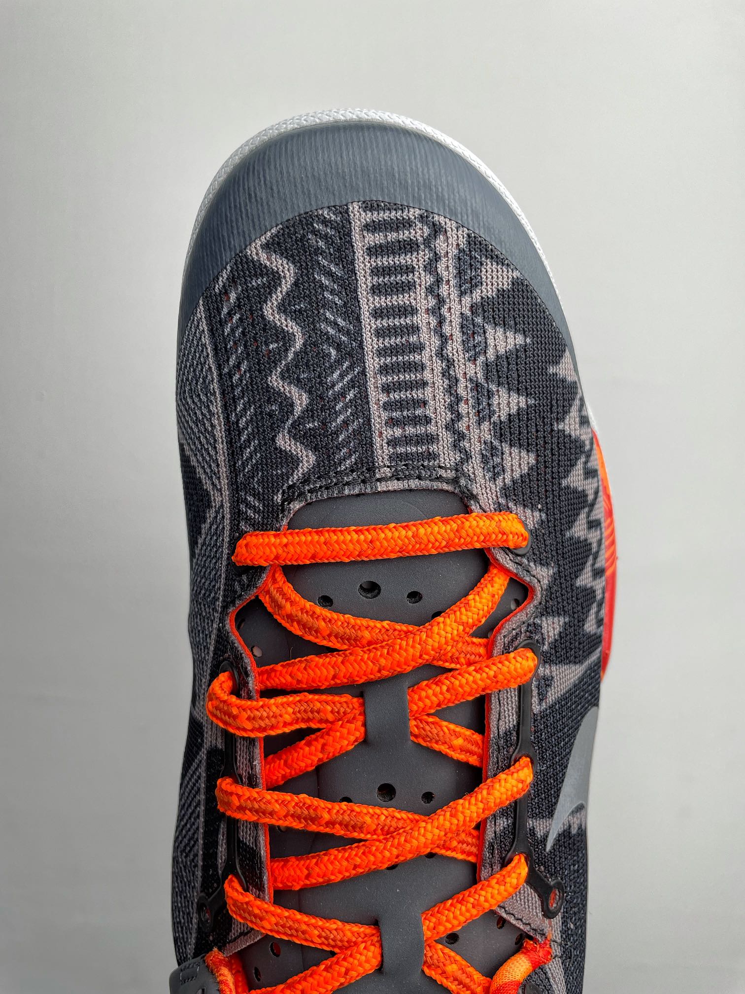Basketball shoes, dark navy toe with orange laces and white interior lining