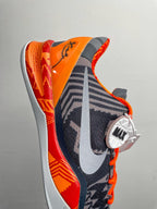Basketball shoes, dark navy with orange heel, white foam sole