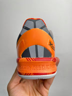 Basketball shoes, orange back collar with dark panels and white outsole