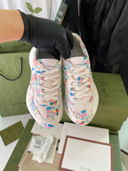 Gucci unisex sneakers pair, front view with multicolor logo-print uppers