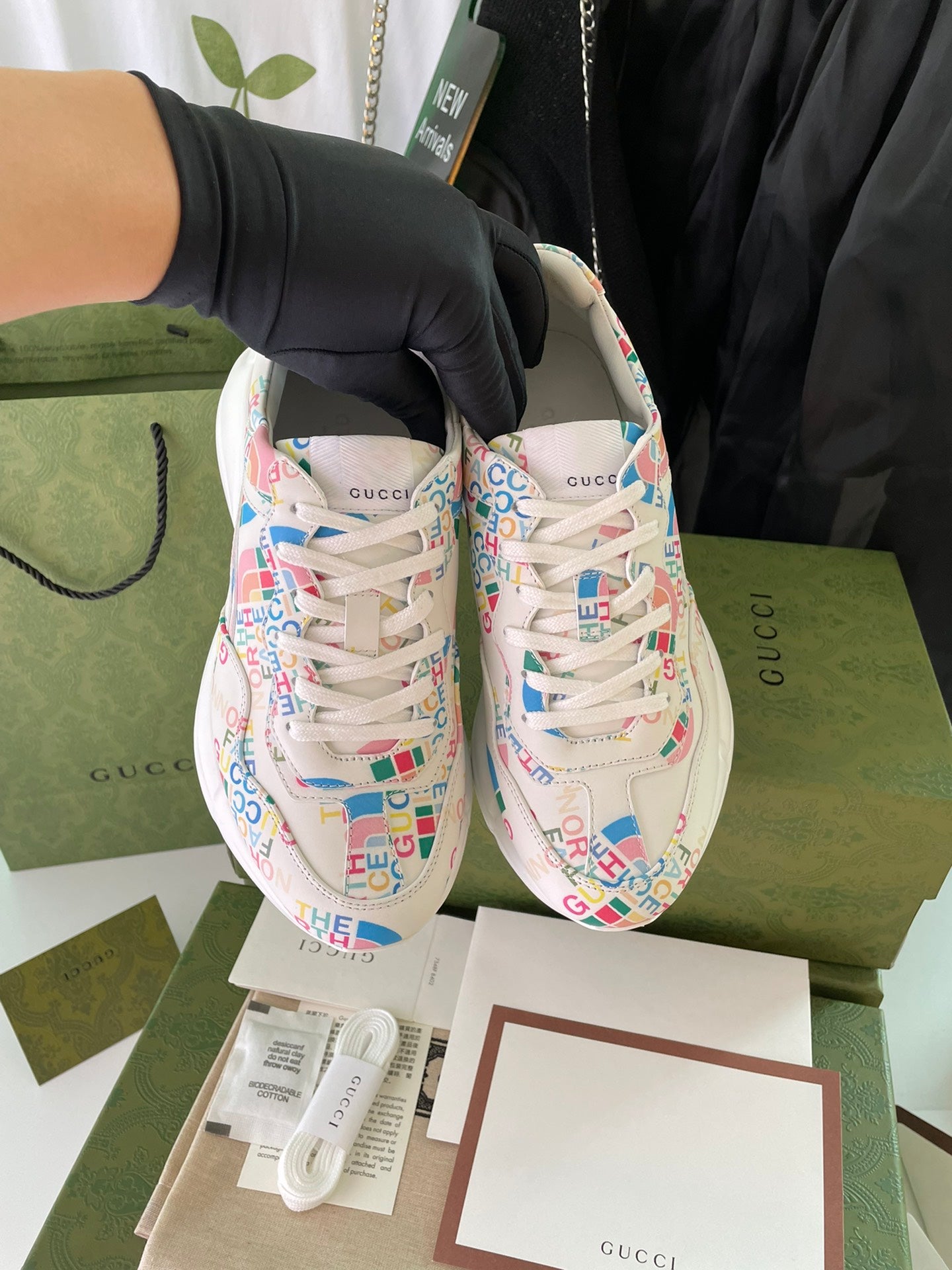 Gucci unisex sneakers pair, front view with multicolor logo-print uppers