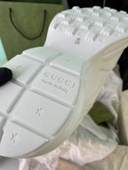 White Gucci sneakers outsole close-up with Gucci branding and star marks