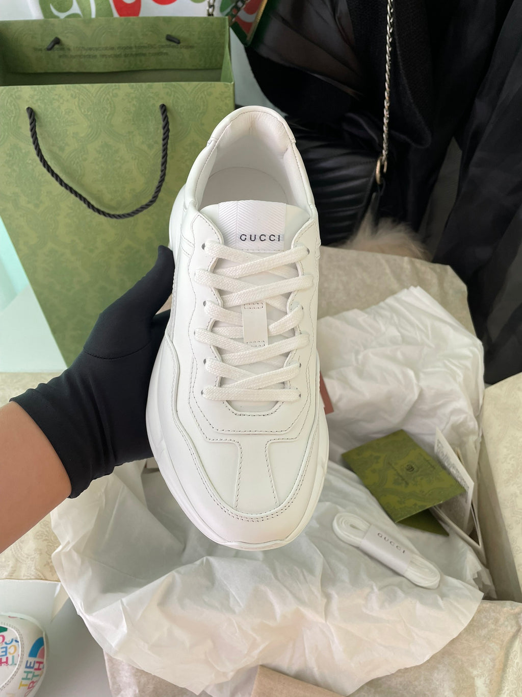 White Gucci lace-up sneakers, front view with stitched panel details