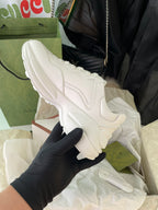White Gucci sneakers, angled side view with padded collar