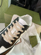 Gucci unisex sneakers, black and white, close-up of toe and beige laces